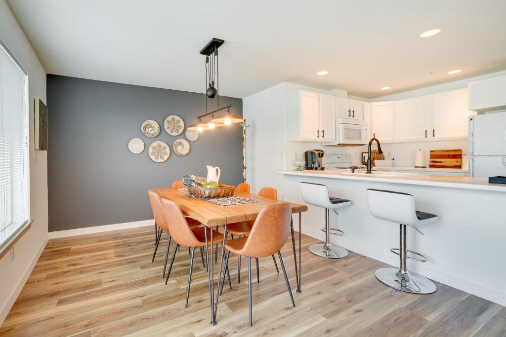 a kitchen and dining room with a wooden table and chairs at Chelan Vacation Rental with Balcony and Views in Chelan