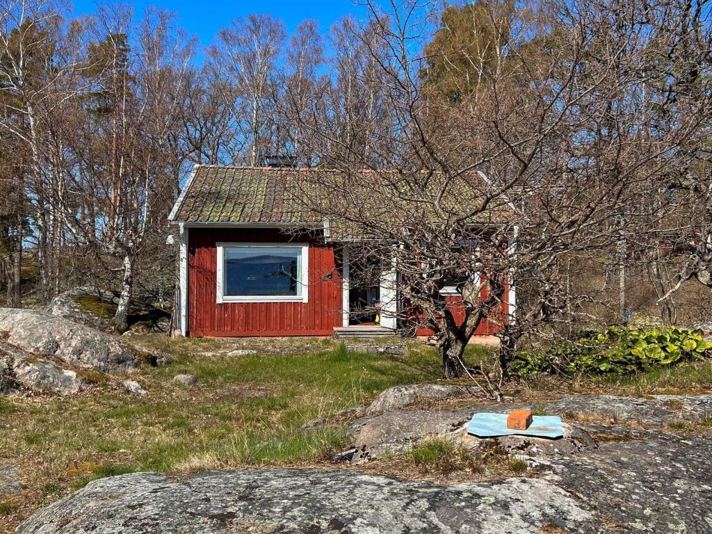 ein kleines rotes Haus mitten auf einem Feld in der Unterkunft Holiday home DALARÖ II in Dalarö