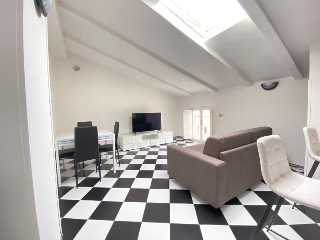 a living room with a black and white checkered floor at Chess House in Azzano Mella