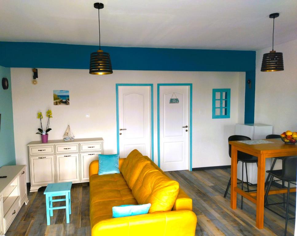 a living room with a yellow couch and a table at Apartments Biondi in Viskovo