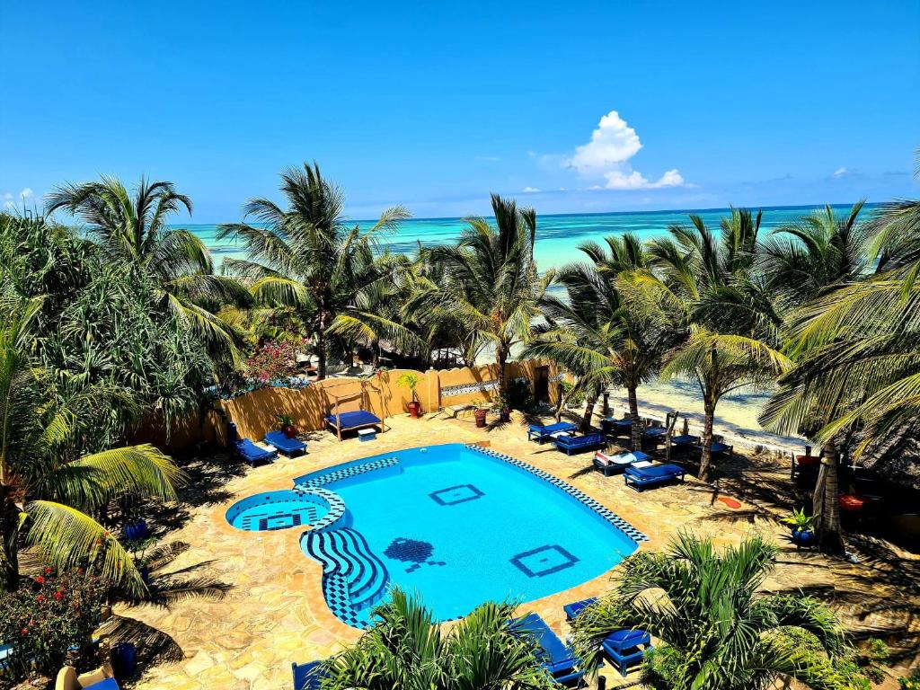 an aerial view of a resort with a swimming pool and the beach at Queen of Sheba Beach Lodge in Pongwe