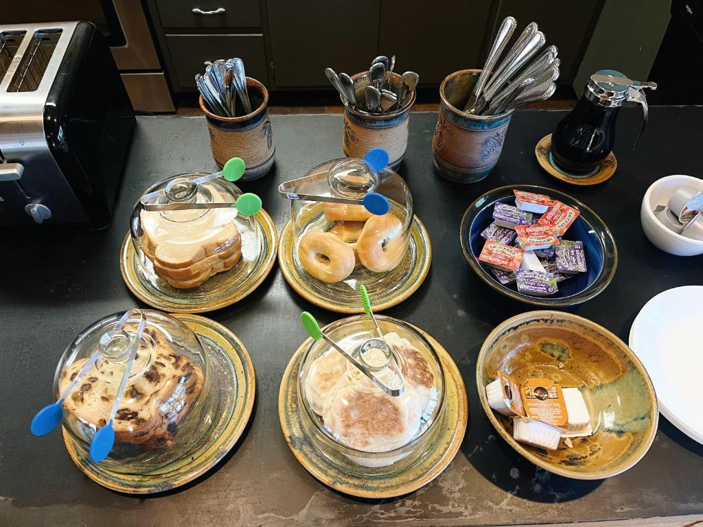 a bunch of plates of food on a counter at Cozy Cabin suite bed and breakfast in Woodland Park