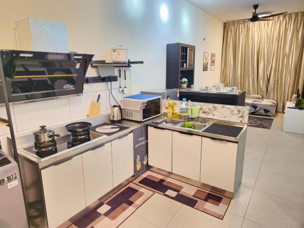 a kitchen with a stove and a counter top at 1 Dream Home @ Canopy Hills 2房1厕完美与齐全设备10分钟到达 UKM in Kajang