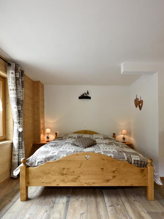 a bedroom with a large wooden bed in a room at Hotel Les Mélèzes in Haudères
