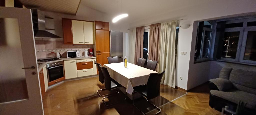 a kitchen with a table with a candle on it at Apartment Nevena in Omiš