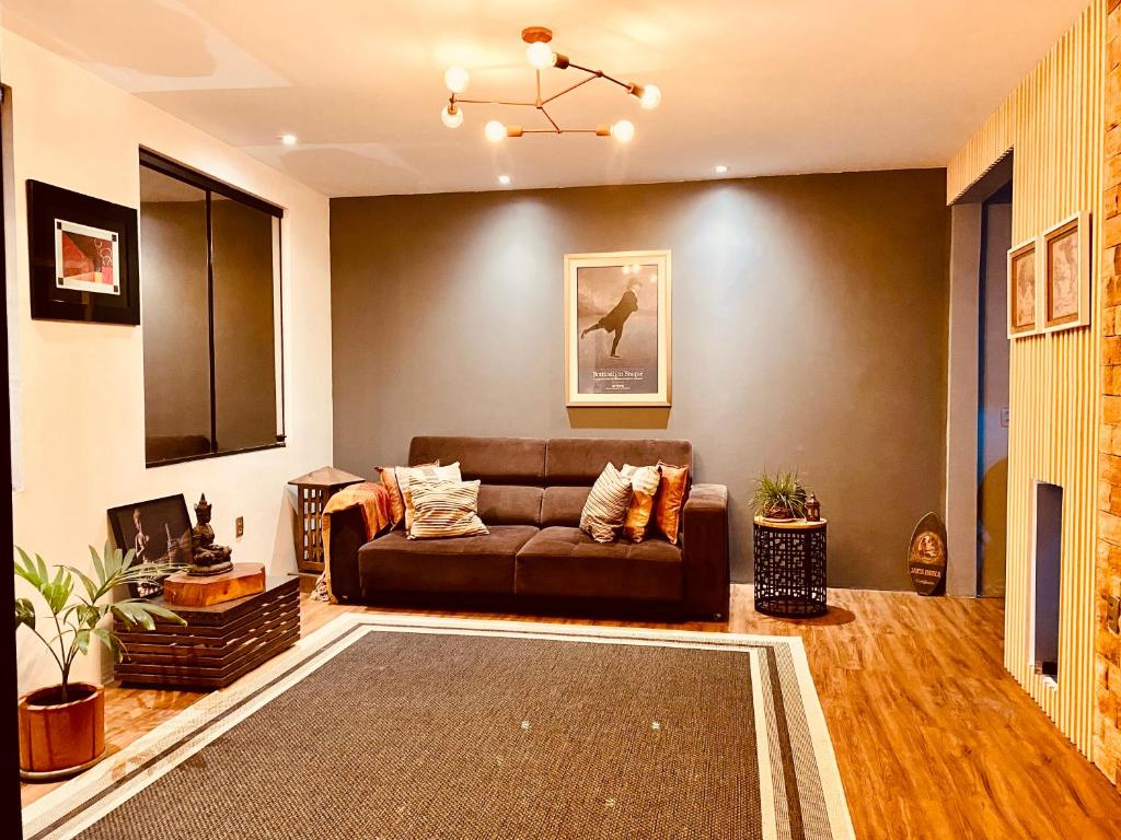 a living room with a couch and a rug at Casa Duplex Aconchegante in Campina Grande