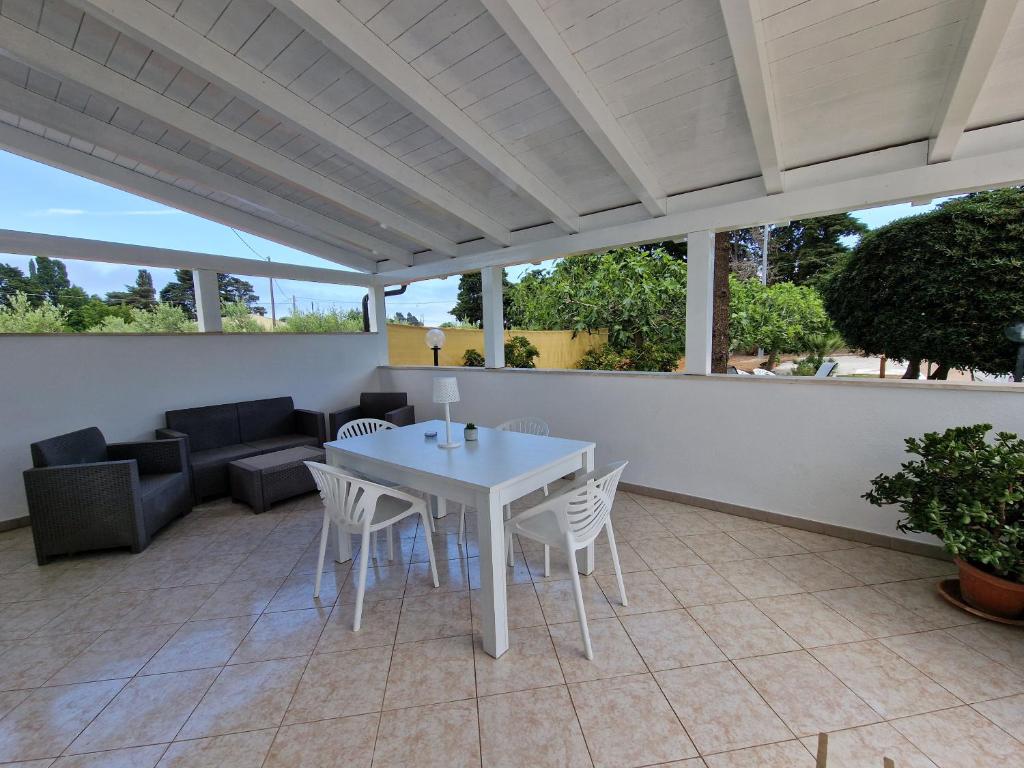 a white table and chairs on a patio at Meraviglia d'Otranto in Otranto