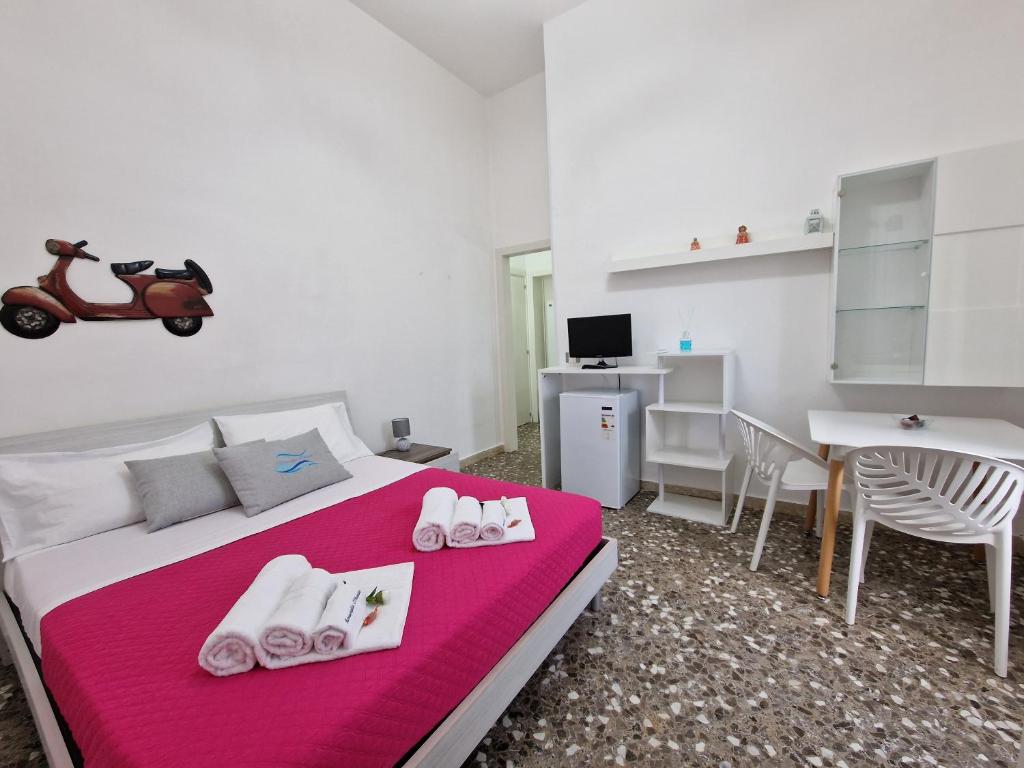a bedroom with a bed with a scooter on it at Meraviglia d'Otranto in Otranto