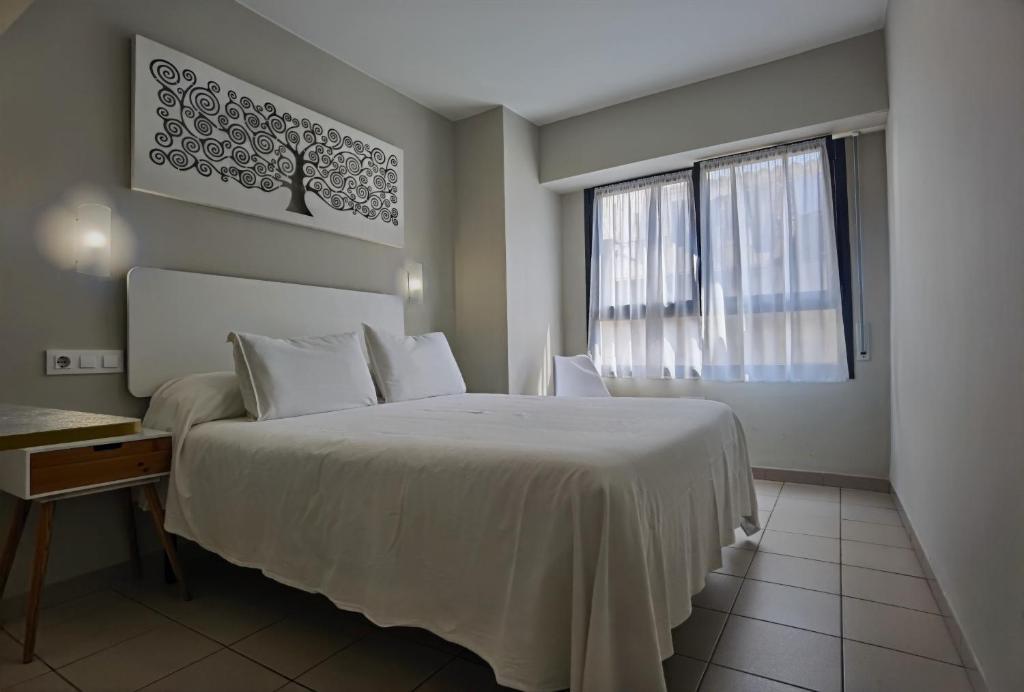 Postel nebo postele na pokoji v ubytování HOSTAL RIGAU