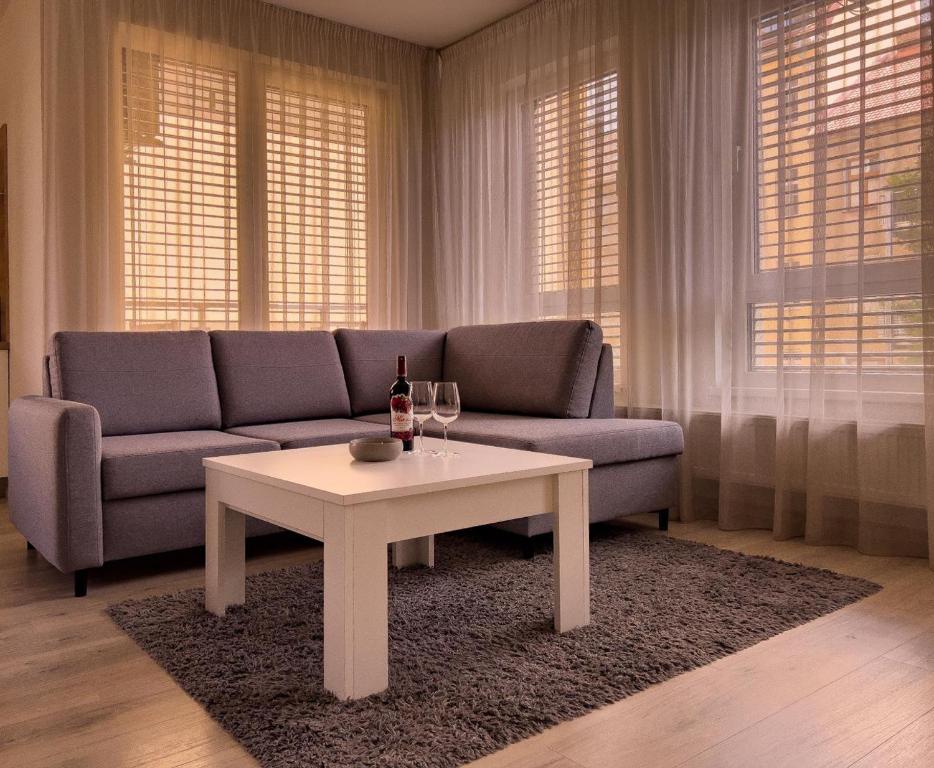 a living room with a couch and a table at Elegant Escape apartment I - City Centre in Bratislava