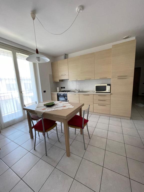 a kitchen with a wooden table and chairs in a room at Franca’s dream - Bellagio in Bellagio