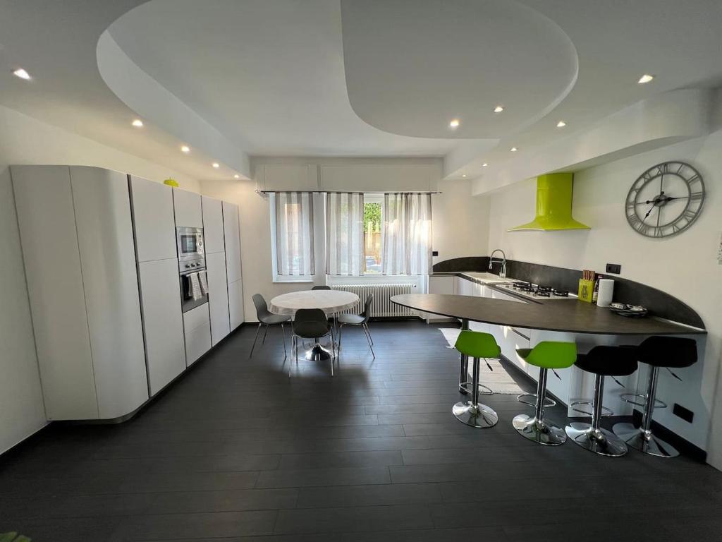 a kitchen with a counter and a table and chairs at Home Stella in Pietra Ligure