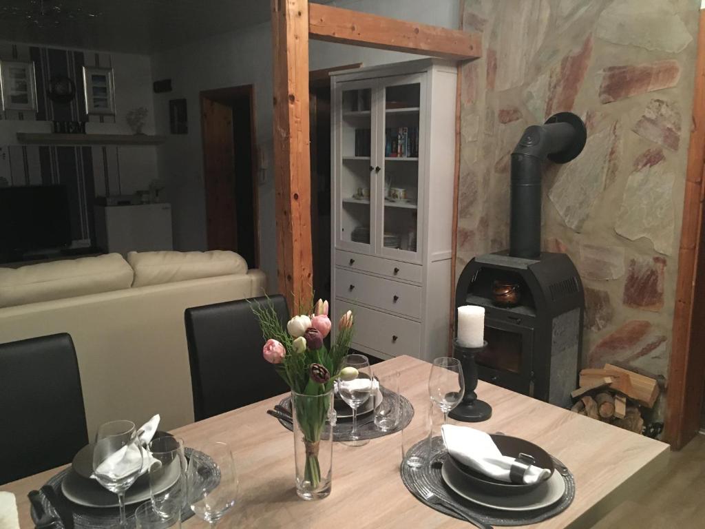 a dining room with a table with a wood stove at Zur alten Zahnradbahn in Sankt Andreasberg