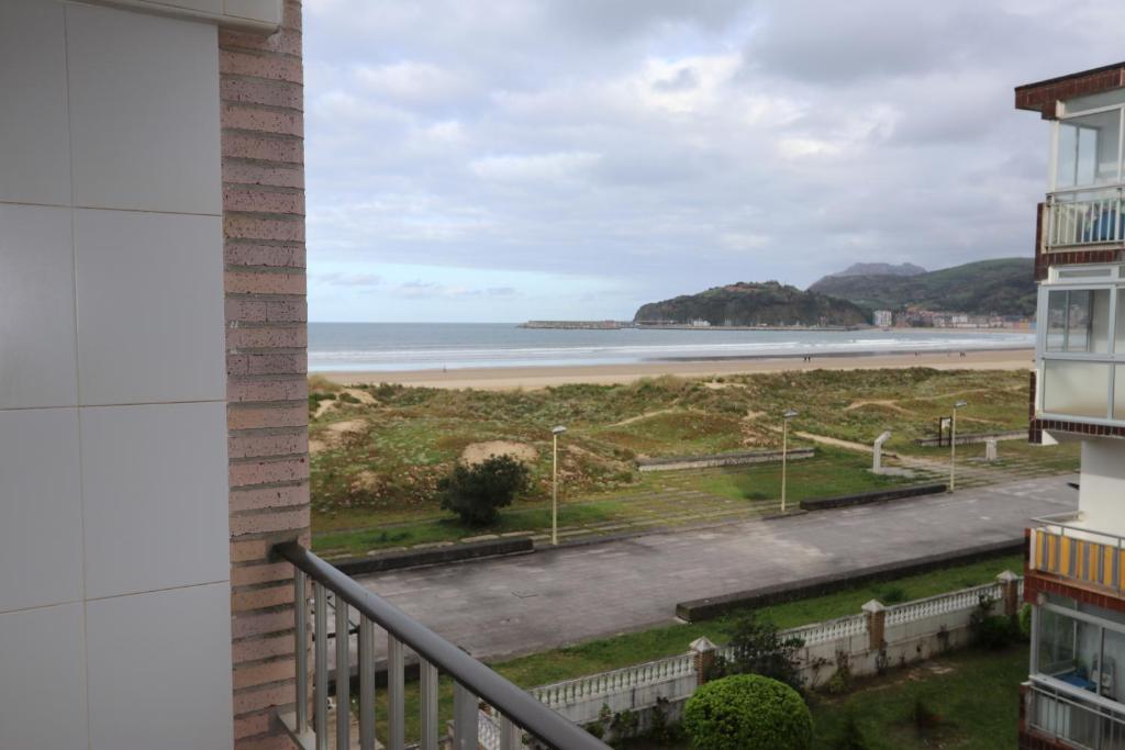 a view of the beach from the balcony of a building at Playa Home Laredo (Vista al Mar) in Laredo