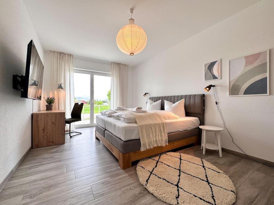 a bedroom with a large bed and a window at Appartio-110 m2-6 Pers-KH Nähe-modern-luxuriös in Villingen-Schwenningen