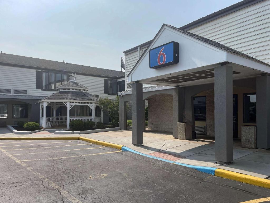 a gas station with a sign on the front of it at Motel 6-Newark, DE in Newark