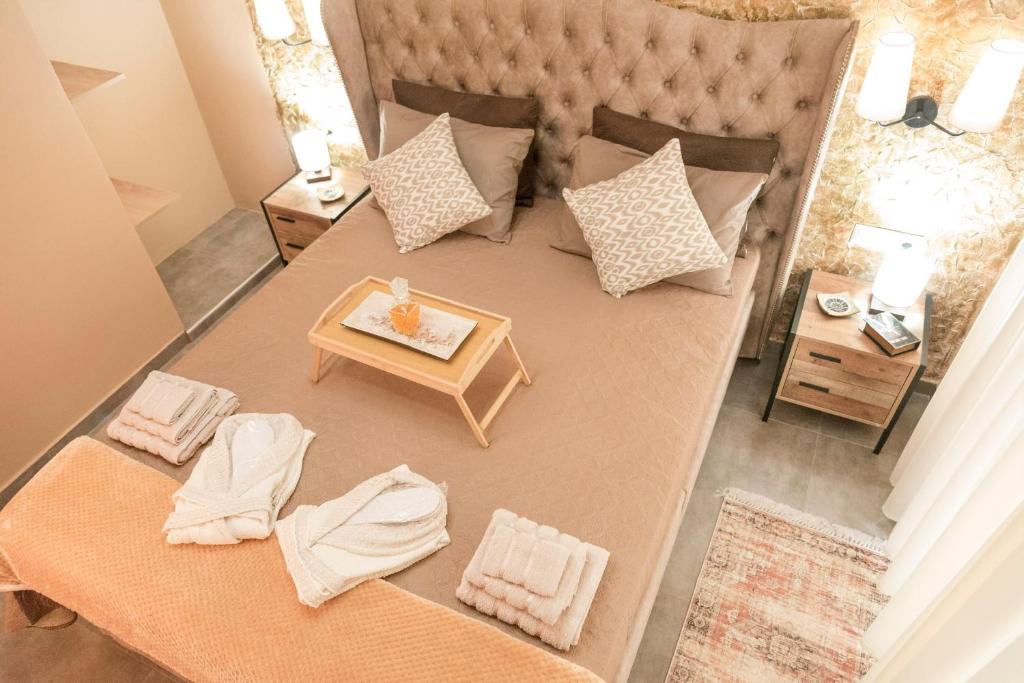 an overhead view of a bed with pillows and a table at The 50/50 Luxury Apartments in Sidari