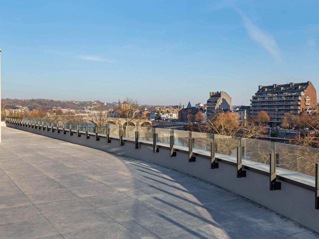 a bridge over a river with a city in the background at Mercure Namur Hotel in Namur