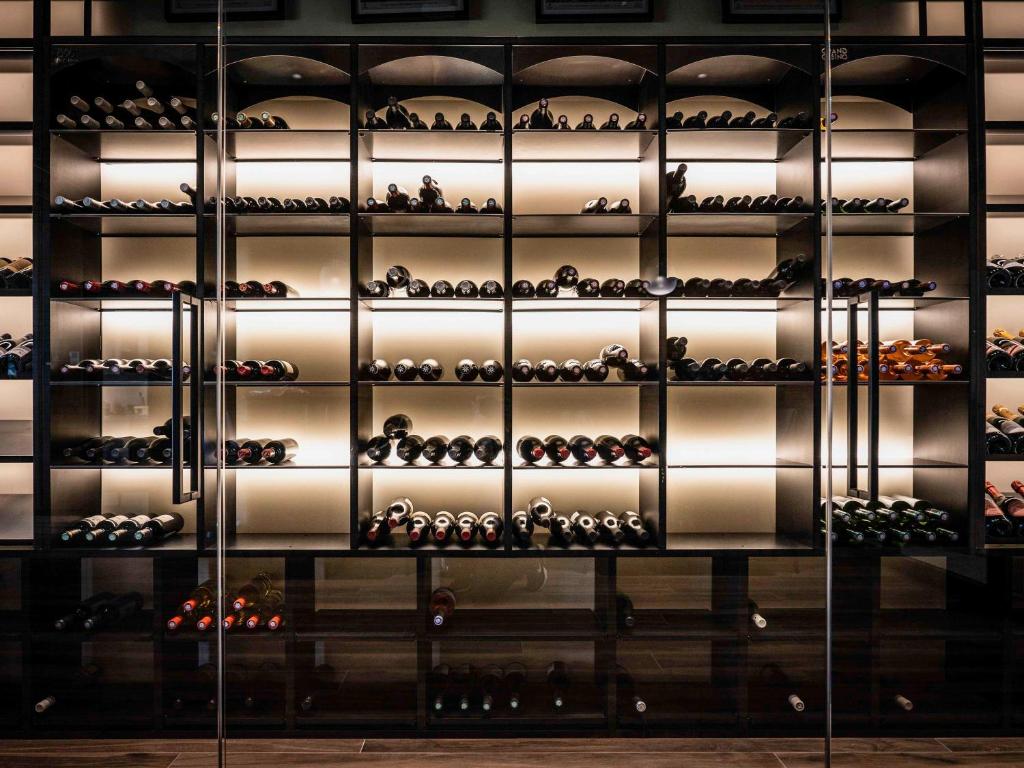 a wall of wine bottles in a wine cellar at Mercure Namur Hotel in Namur