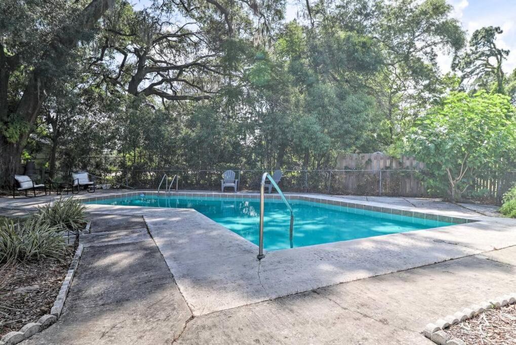a swimming pool in a yard with trees at Pool home sleeps 6 with large fenced yard in Jacksonville