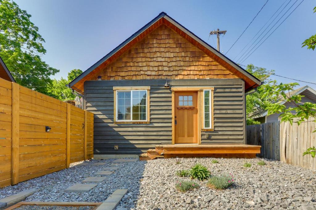 a small house with a wooden fence in front of it at Cozy Coeur dAlene Studio, Walk to Downtown and Lake in Coeur d'Alene