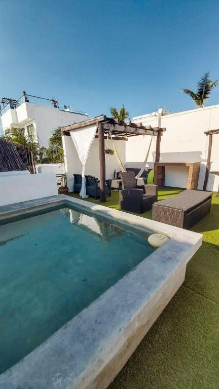 a swimming pool in front of a house at Areli in Playa del Carmen