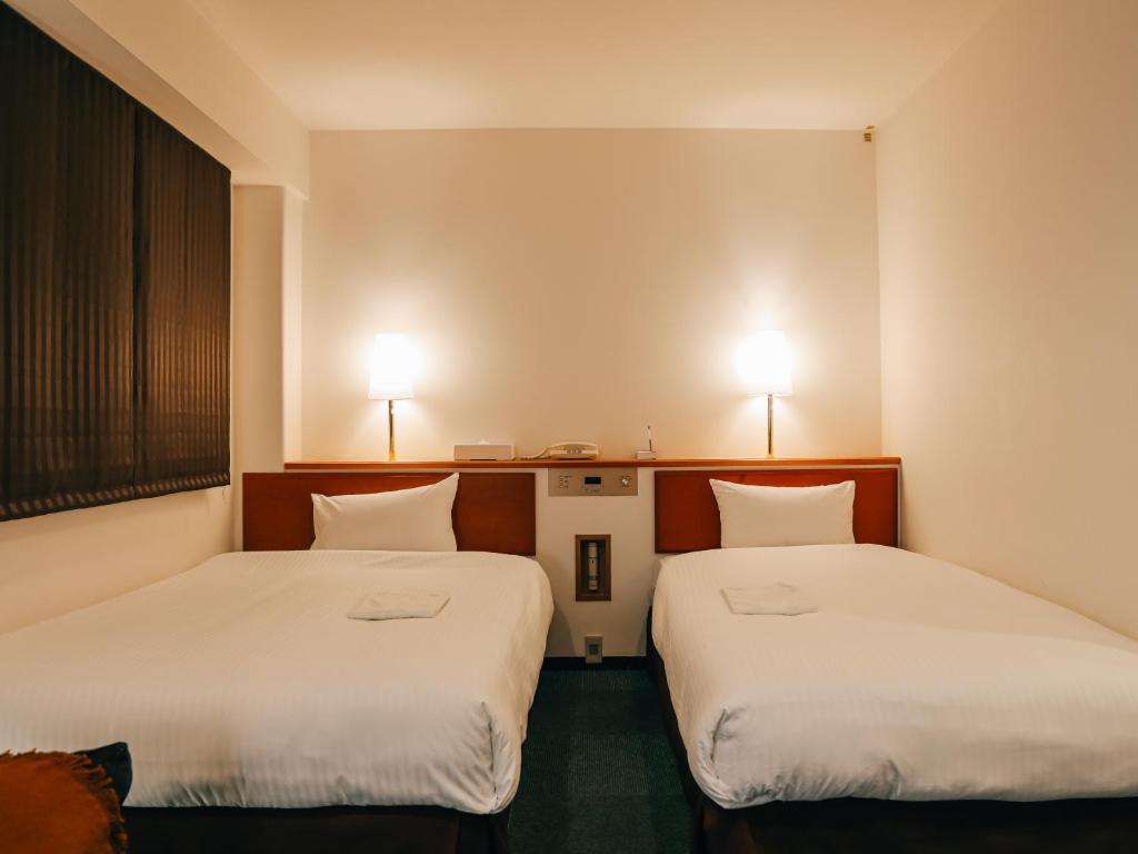 Postel nebo postele na pokoji v ubytování 3s HOTEL HIRATSUKA