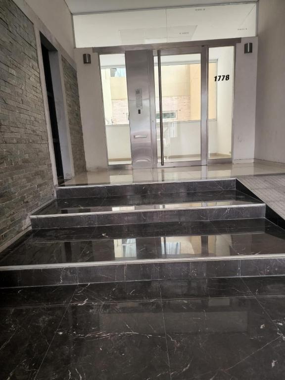 an empty lobby with a row of elevators in a building at Departamento Quality Belgrano in Santiago del Estero