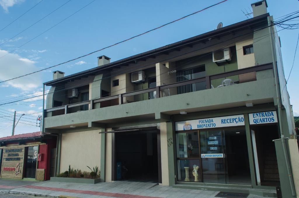 a building on a street in front at Pousada Bronzatto in Garopaba