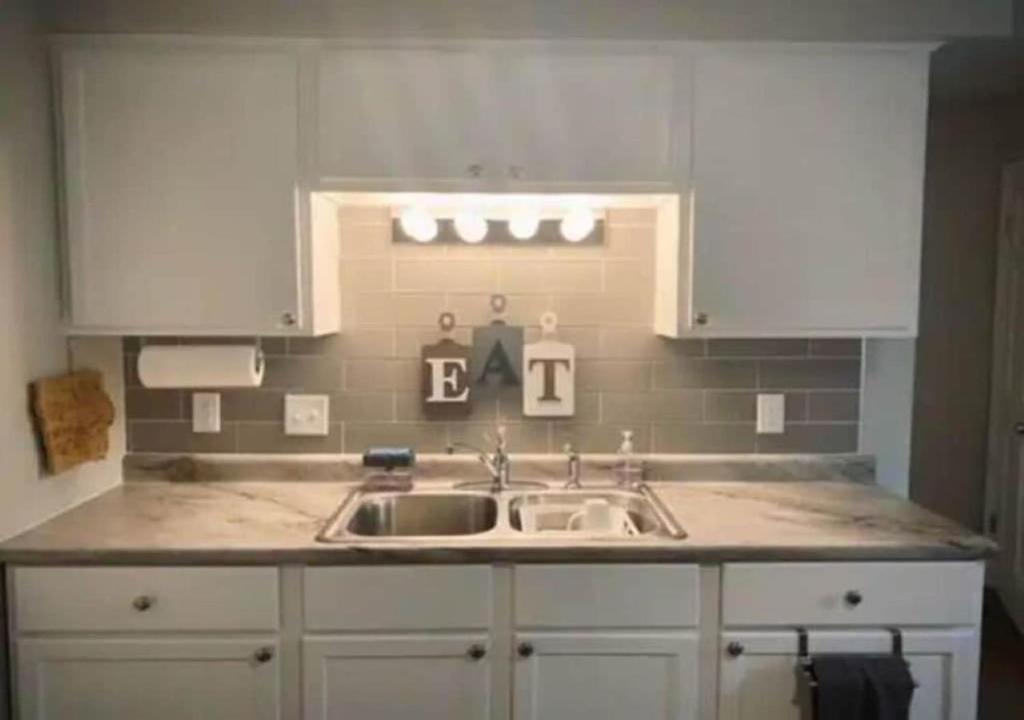 a kitchen counter with a sink and a window at NYC — Newark Airport with Office! in Newark