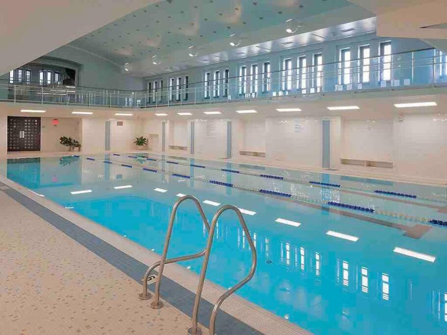 a large swimming pool in a large building at Beautiful Condo/Rooftop Patio With Free Parking in Cleveland