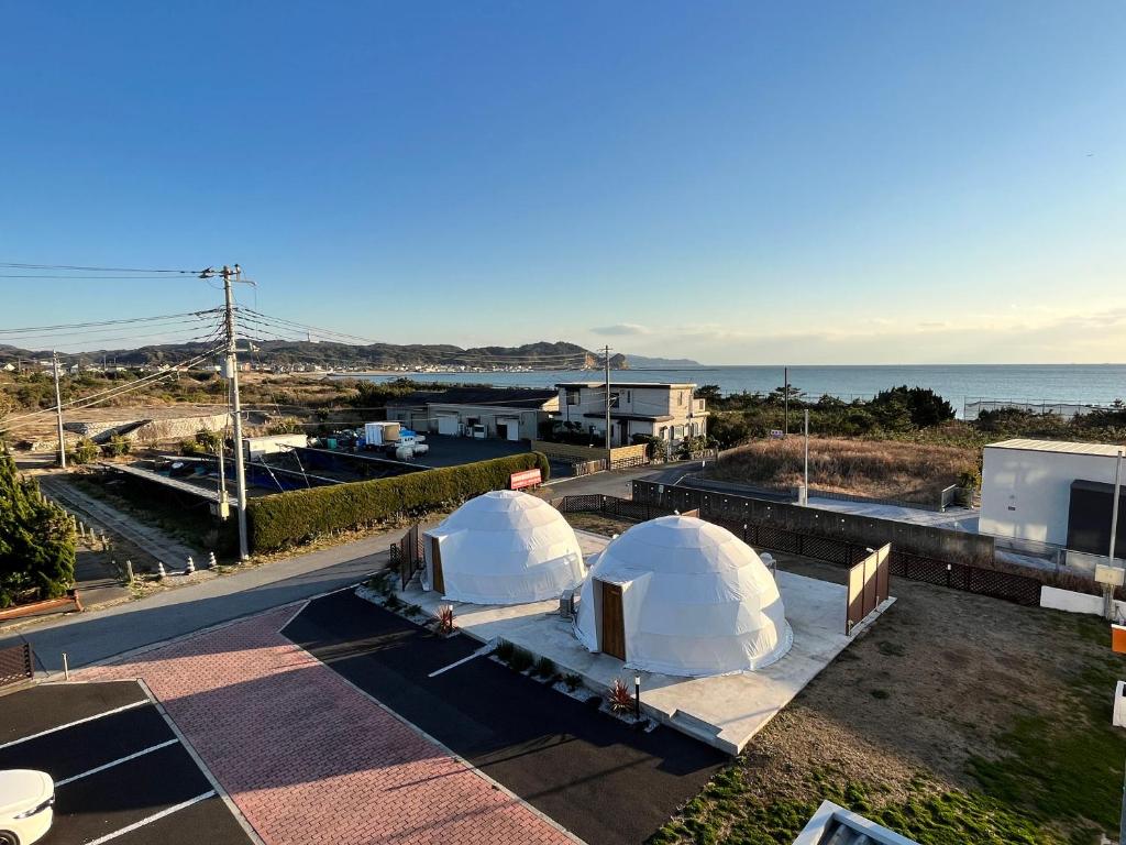 two domes on top of a building near the ocean at Hotel & Glamping ACT FUTTSU in Futtsu