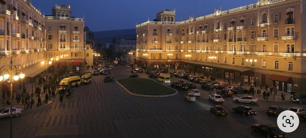 a city street with cars parked in front of buildings at Casa Bonita in Tbilisi City