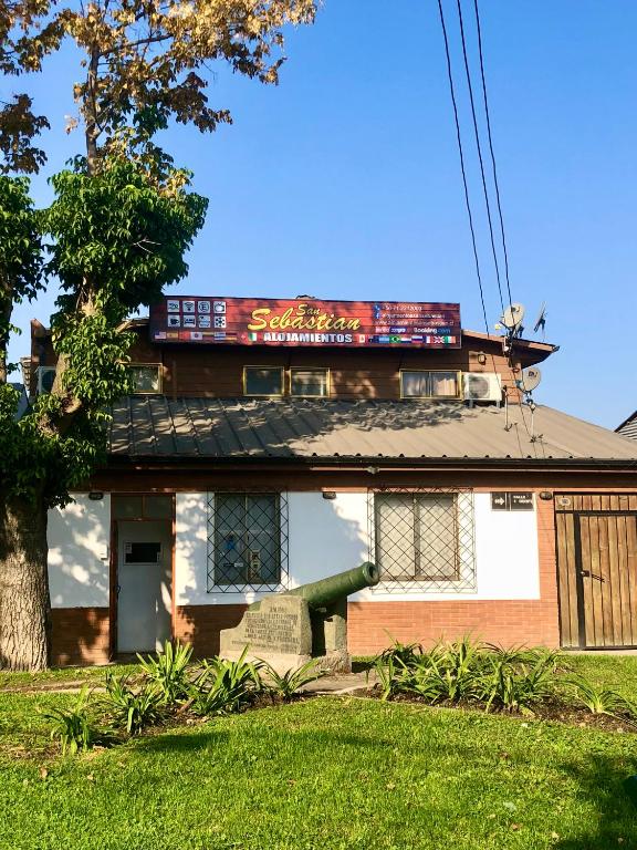 a house with a sign on the top of it at Alojamientos San Sebastián Talca in Talca