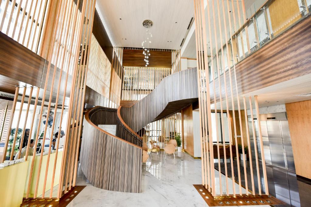 a lobby with a spiral staircase in a building at Lovina 31-ABAC at One Residence in Batam Center