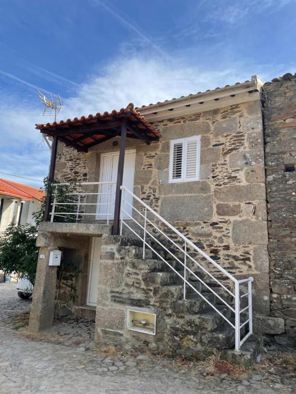 un bâtiment en pierre avec un escalier sur son côté dans l'établissement Casa do fundo do povo, 