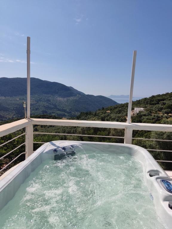 uma banheira de hidromassagem com vista para as montanhas em STATHIS GUESTHOUSE em Lefkada