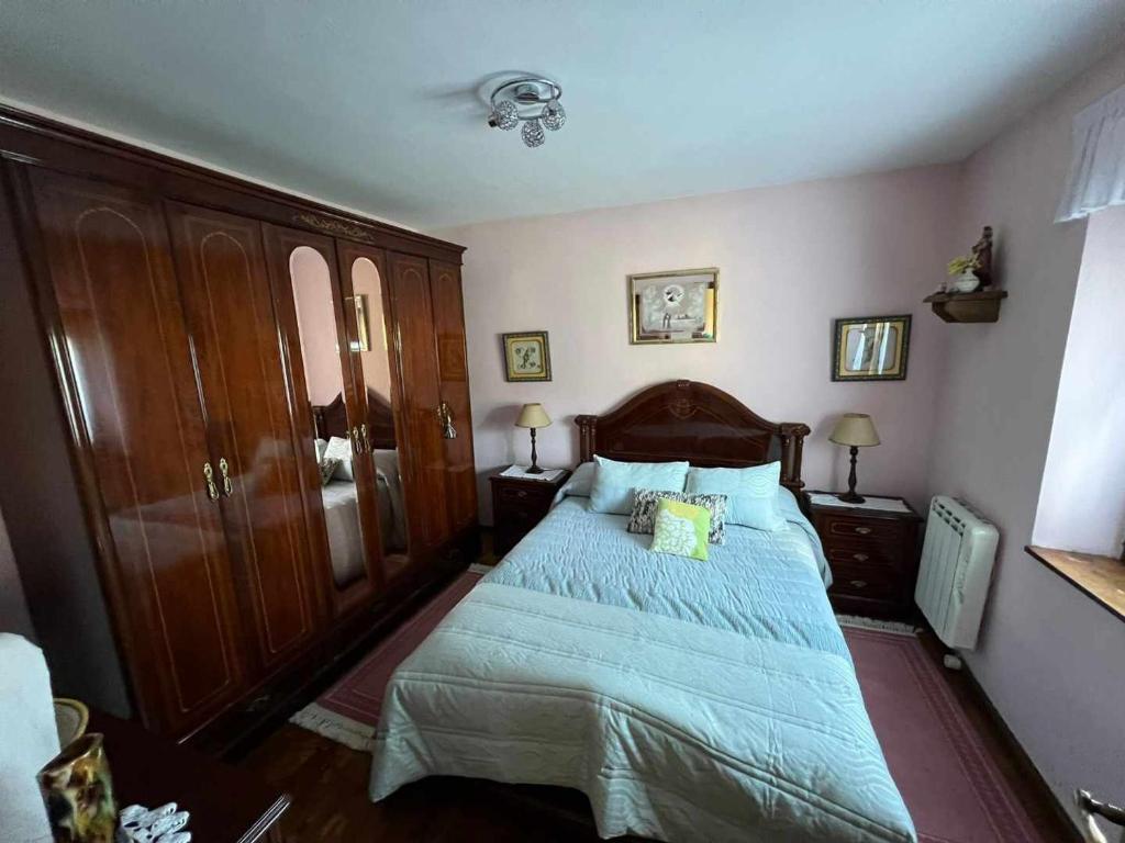 a bedroom with a bed with a blue comforter at Casa Rural La Pereda in Noriega