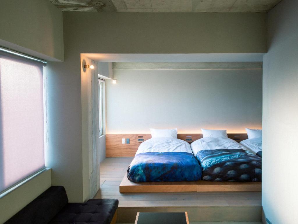 Postel nebo postele na pokoji v ubytování Kagan Hotel & Hostel