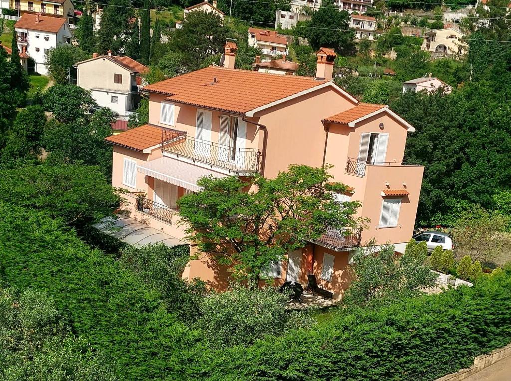 a large house on the side of a hill at Apartments Mogorović in Mošćenička Draga