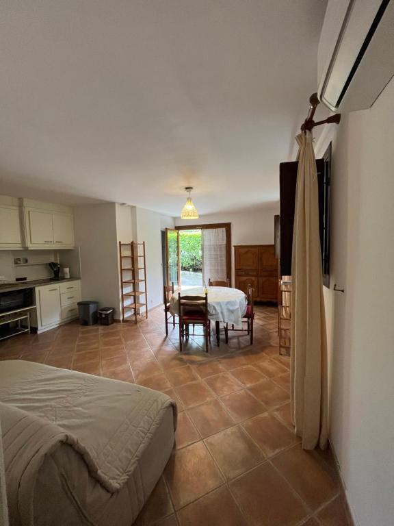 a bedroom with a bed and a kitchen with a table at Corte Appartement T2 en résidence privée in Corte
