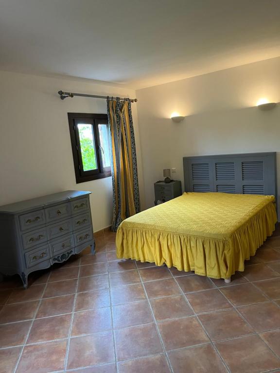 a bedroom with a bed and a dresser and a window at Corte Appartement T2 en résidence privée in Corte