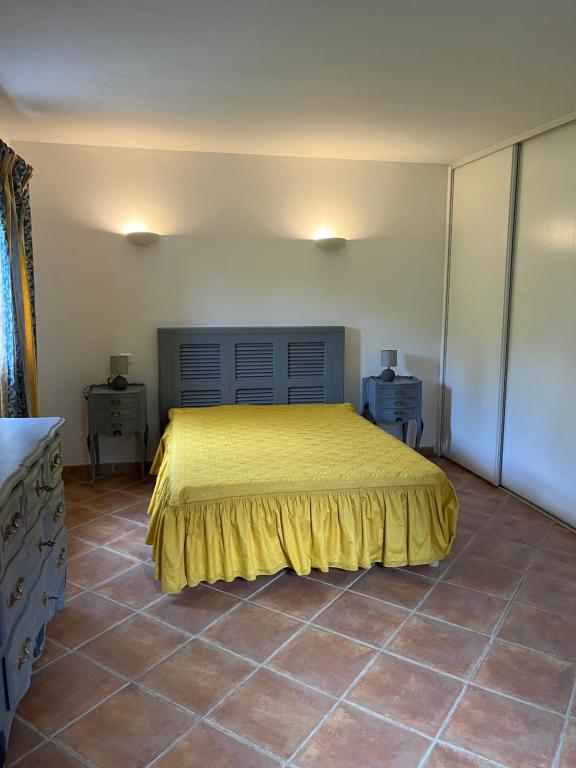 a bedroom with a bed with a yellow bedspread at Corte Appartement T2 en résidence privée in Corte
