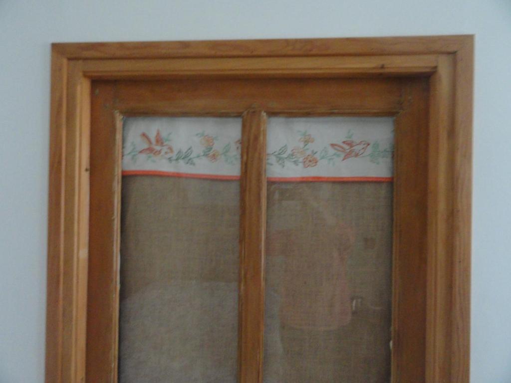 a wooden window with curtains in a room at Les chambres de Blanot in Blanot