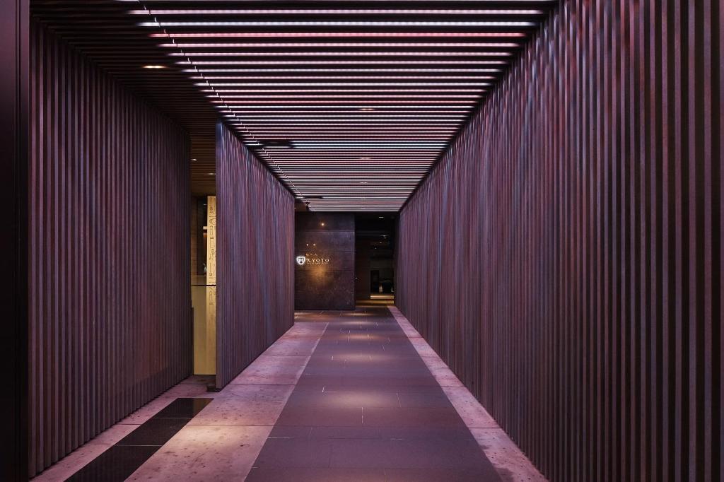 a hallway of a building with a red wall at The Royal Park Hotel Kyoto Sanjo in Kyoto