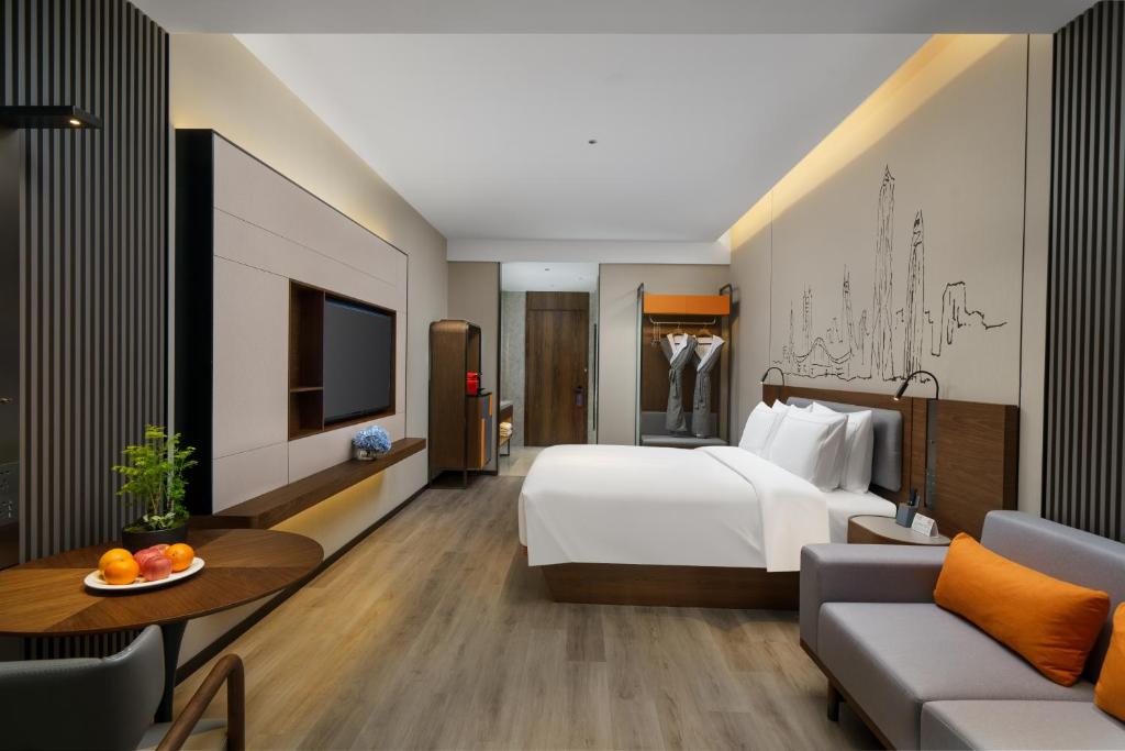 Un pat sau paturi într-o cameră la UrCove by HYATT Futian CBD-毗邻福田站和星河COCO Park 尊享免费迷你吧