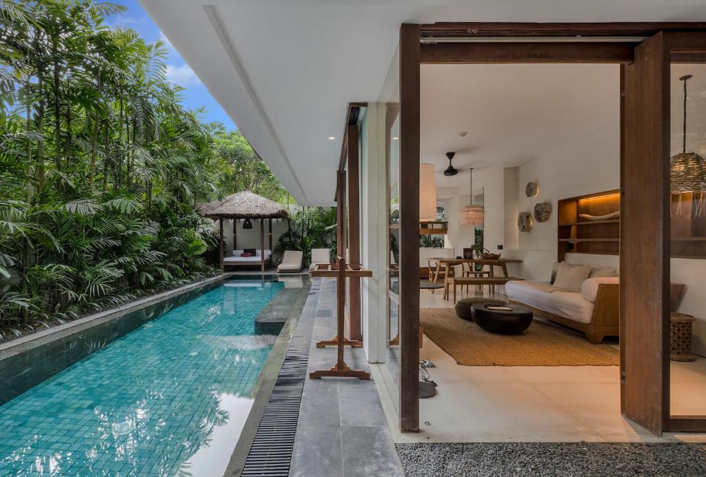 an infinity pool in the living room of a villa at Bisma Eight Villas in Ubud