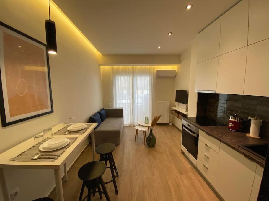 a kitchen and living room with a table and chairs at Piraeus cozy appartment rental in Piraeus