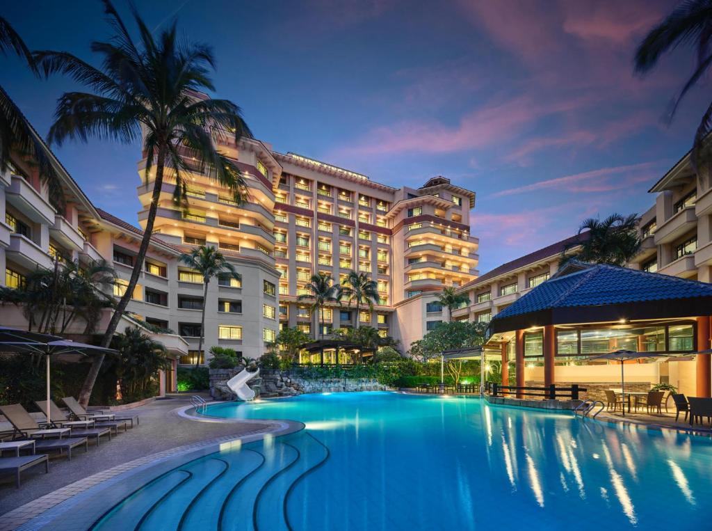 a hotel with a swimming pool in front of a building at Paradox Singapore Merchant Court at Clarke Quay in Singapore