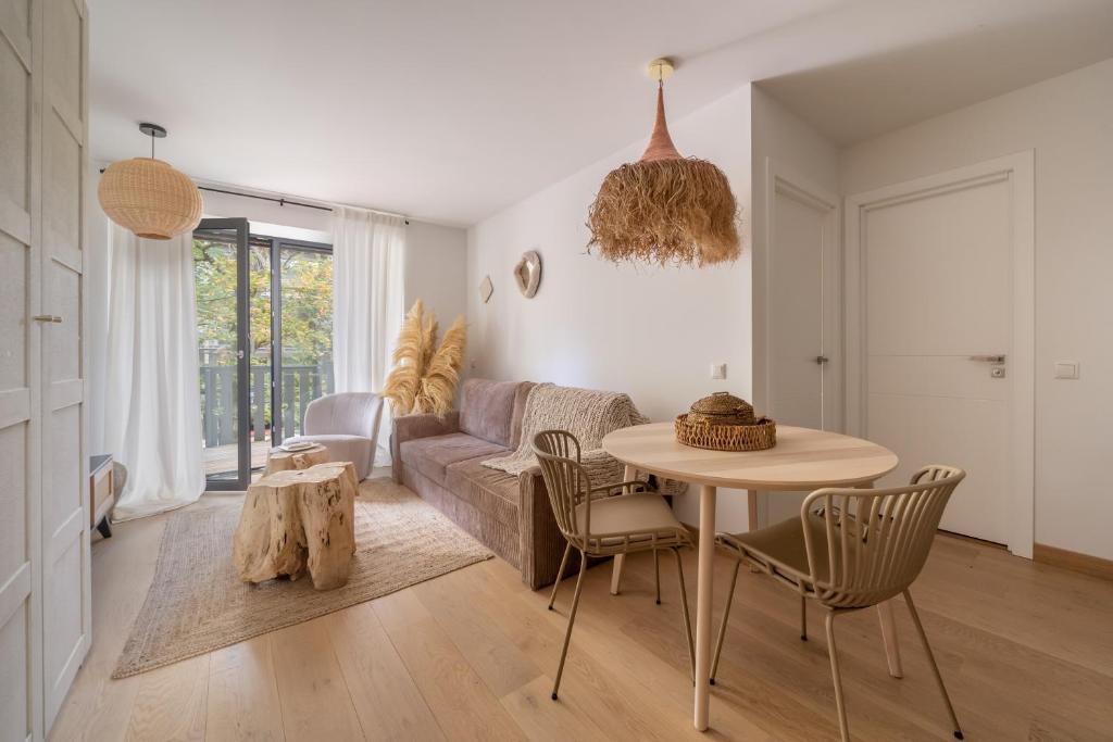 a living room with a table and a couch at Jurmala seaside apartment with balcony in Jūrmala